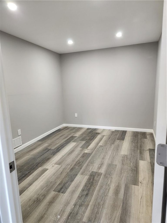 unfurnished room with wood-type flooring