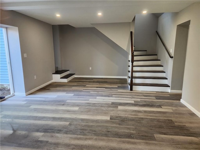 basement with dark hardwood / wood-style floors