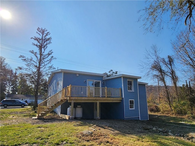 rear view of property featuring a deck