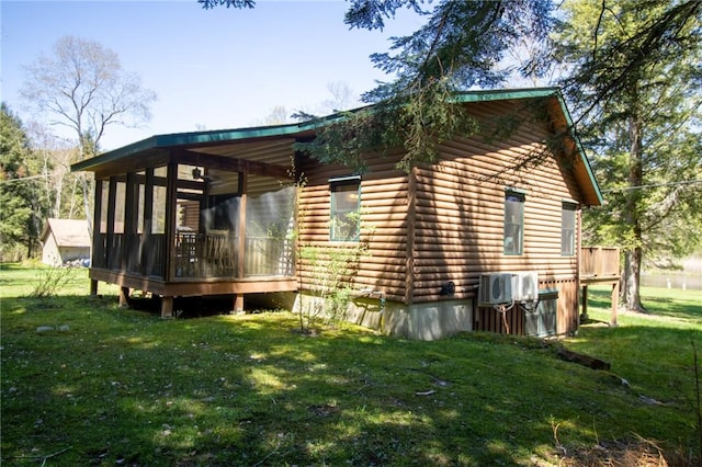 view of home's exterior with a sunroom and a yard