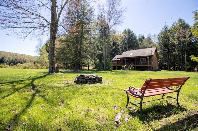 view of yard featuring a fire pit and a deck