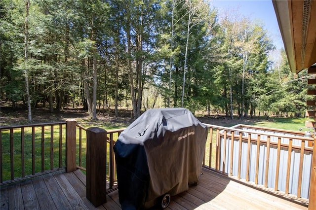 wooden deck featuring a grill