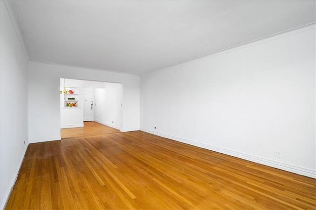 empty room featuring baseboards and wood finished floors