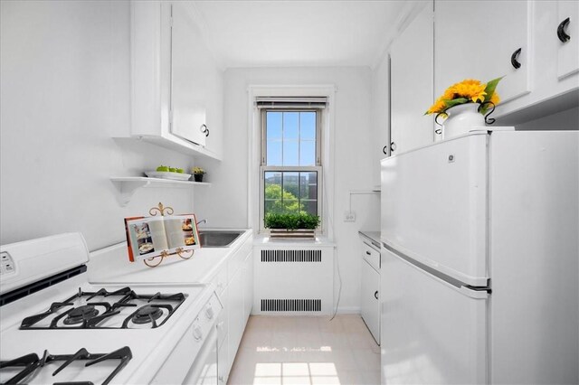 kitchen featuring white appliances, white cabinets, light countertops, radiator, and open shelves