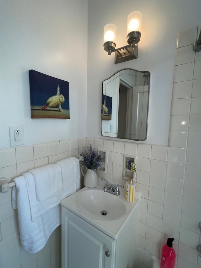 bathroom with vanity and tile walls