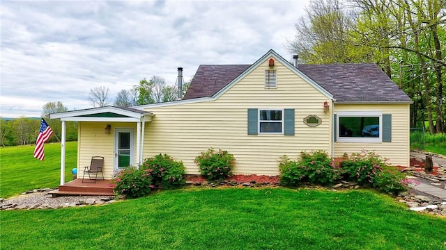 back of house with a lawn