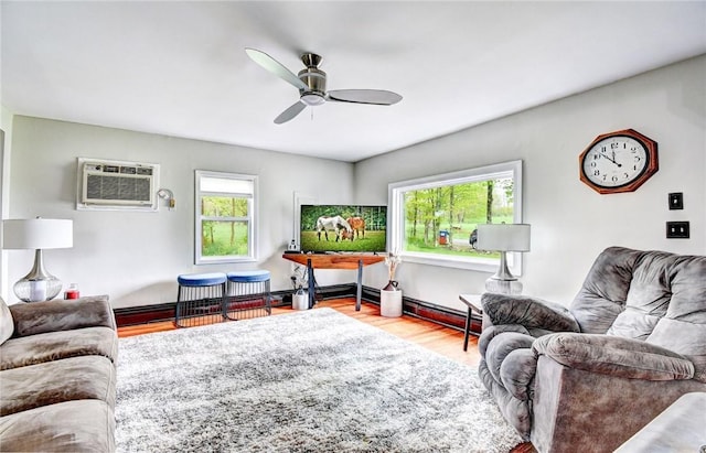 living room featuring light hardwood / wood-style flooring, a wall mounted AC, and ceiling fan