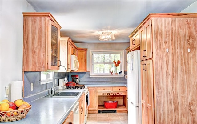 kitchen featuring white appliances and sink