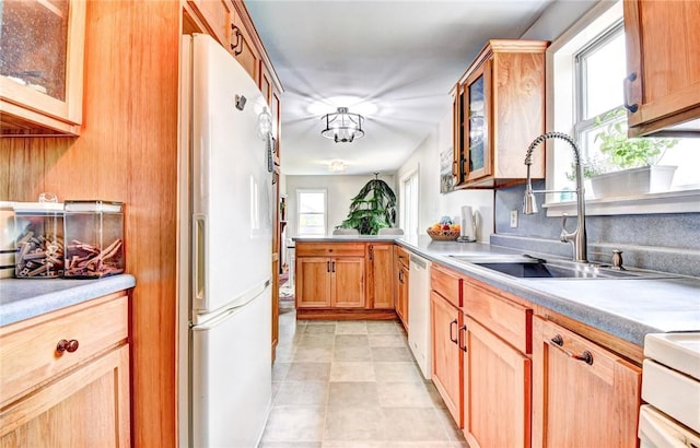 kitchen featuring sink and white appliances