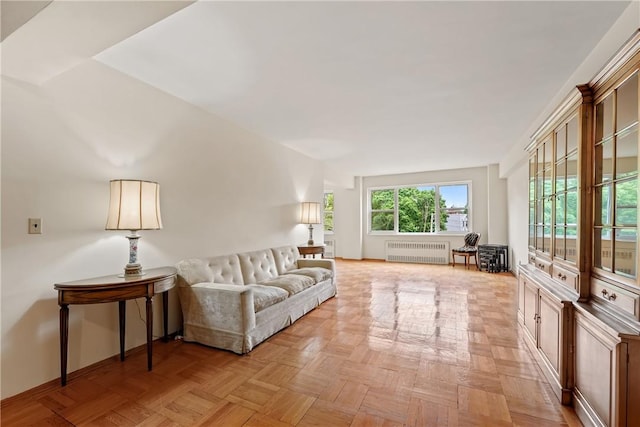 living room with radiator heating unit and light parquet floors