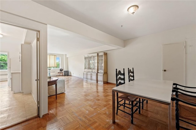 dining room with parquet flooring and radiator