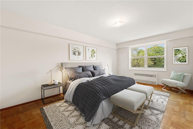 bedroom with radiator and parquet flooring