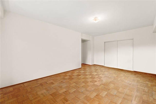 unfurnished bedroom featuring light parquet flooring