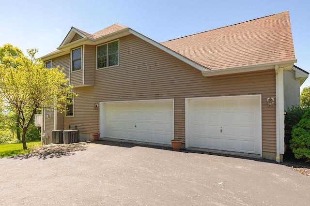 view of home's exterior featuring a garage and central air condition unit