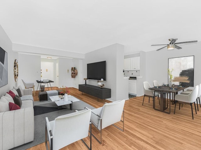 living room with ceiling fan and light hardwood / wood-style floors