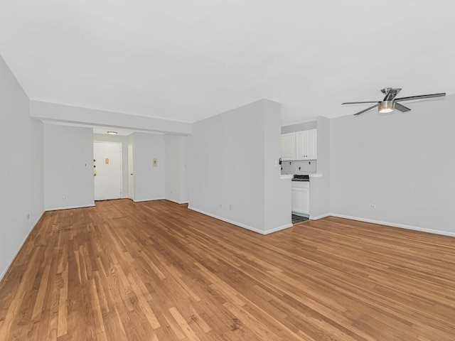 unfurnished living room featuring ceiling fan and light hardwood / wood-style flooring