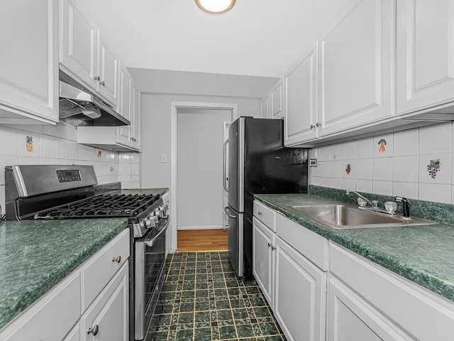 kitchen featuring white cabinets, decorative backsplash, sink, and appliances with stainless steel finishes