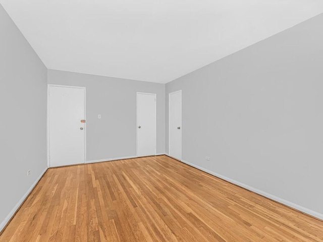 empty room with light hardwood / wood-style flooring