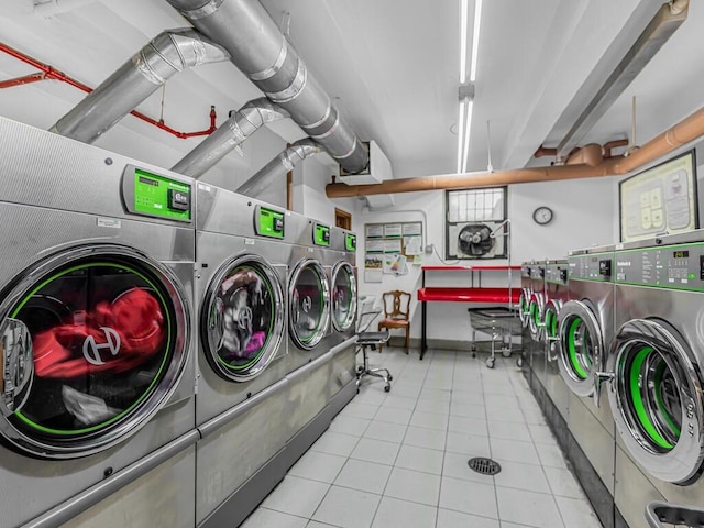 laundry room with light tile patterned floors and washer and dryer