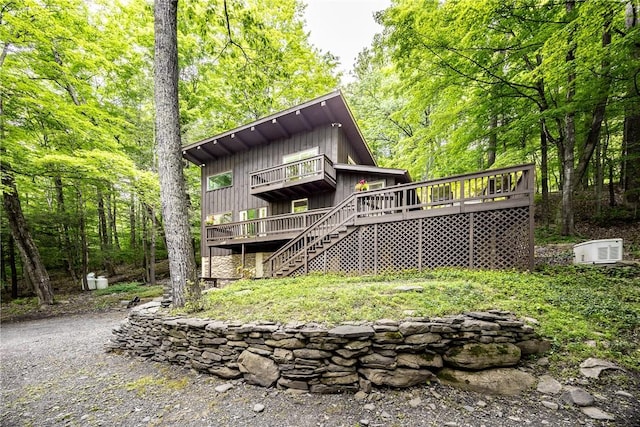 rear view of house featuring a wooden deck