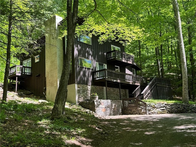 back of house with a balcony and a deck