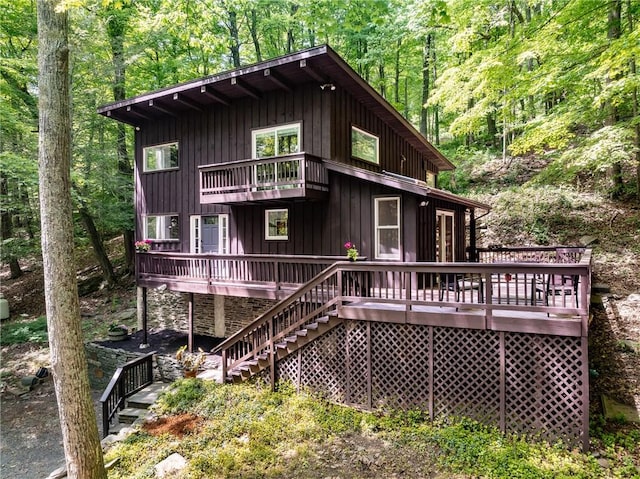 rear view of house featuring a wooden deck