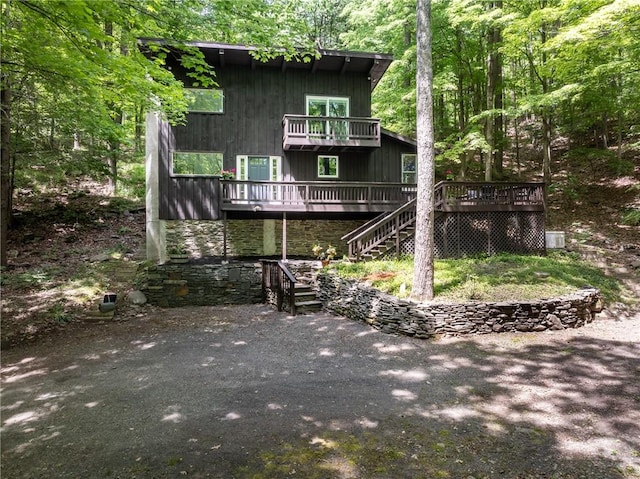 rear view of property featuring a wooden deck