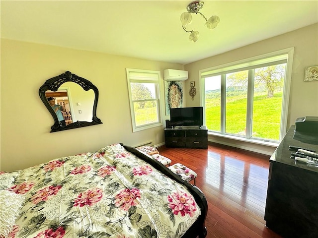 bedroom featuring a wall mounted AC and dark hardwood / wood-style flooring