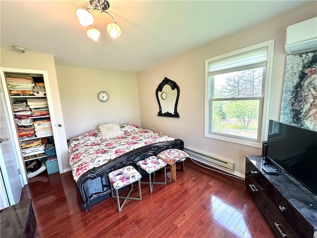 bedroom featuring dark wood-type flooring, a wall unit AC, and a baseboard radiator