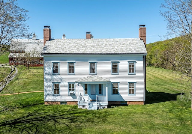 rear view of house with a yard