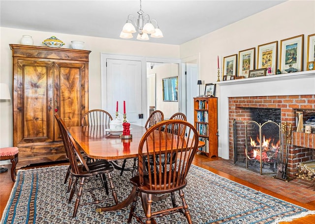 dining room with a fireplace and a chandelier