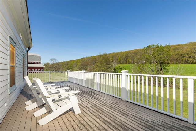 wooden terrace with a lawn