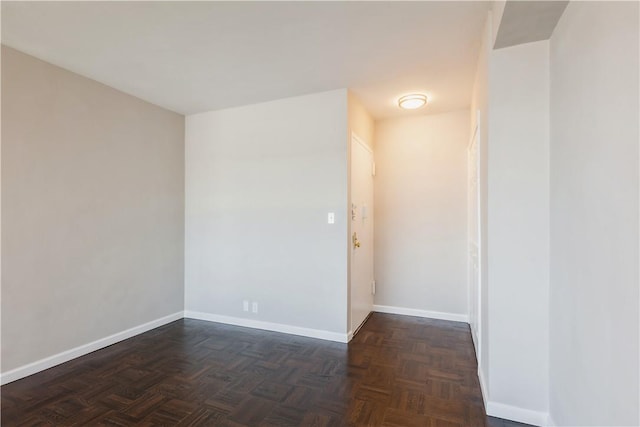 unfurnished room with dark parquet floors