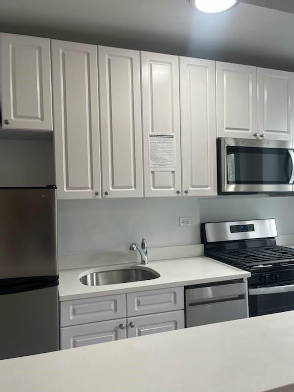 kitchen featuring white cabinetry, sink, and stainless steel appliances