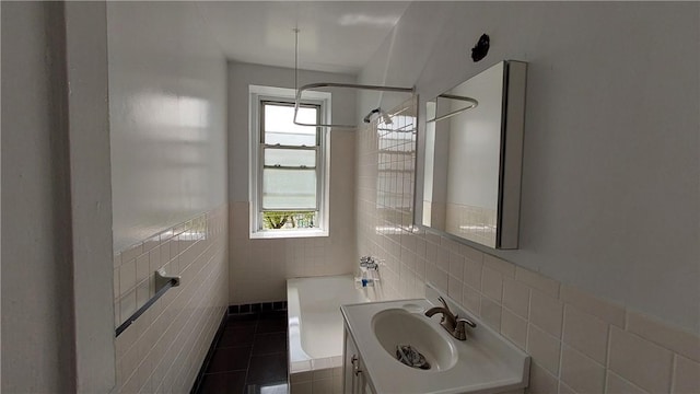 bathroom featuring a tub, plenty of natural light, tile walls, and sink