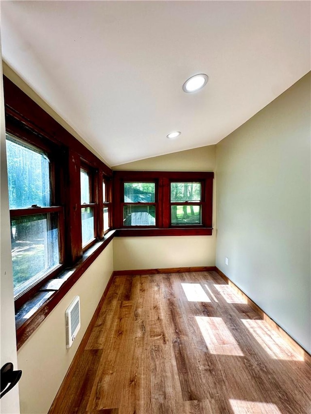 unfurnished sunroom featuring lofted ceiling