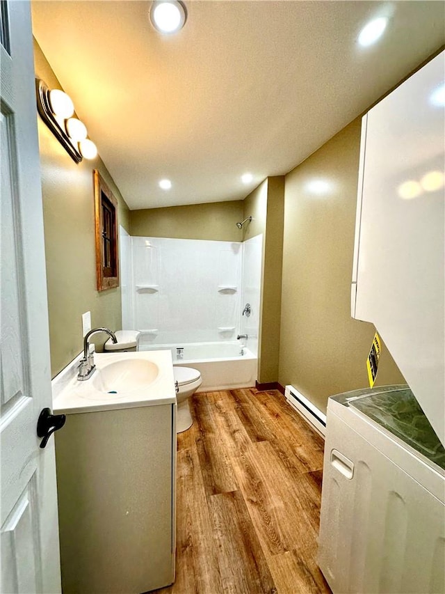 full bathroom with tub / shower combination, a baseboard radiator, vanity, toilet, and hardwood / wood-style flooring