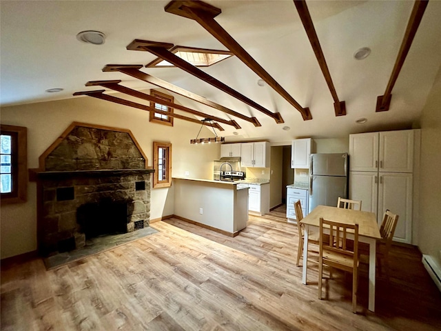 living room featuring baseboard heating, a fireplace, light hardwood / wood-style flooring, and lofted ceiling with beams