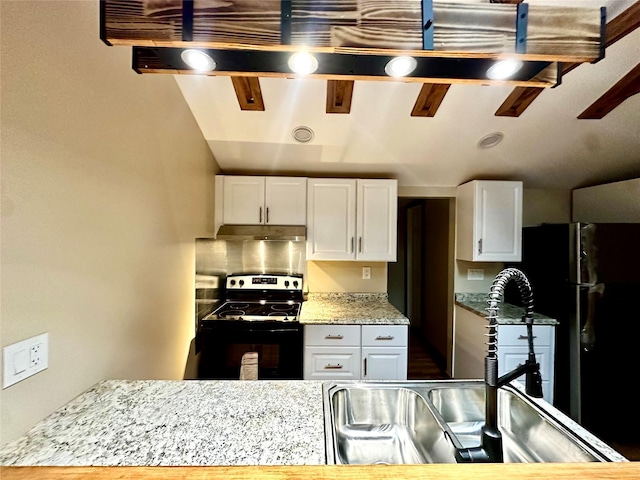 kitchen with light stone countertops, electric range oven, and white cabinetry