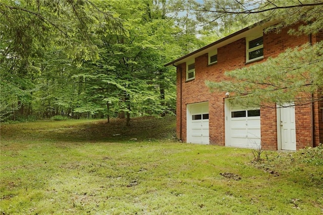 view of home's exterior featuring a lawn and a garage