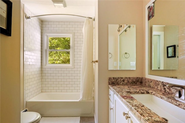 full bathroom featuring shower / bath combination with curtain, vanity, and toilet