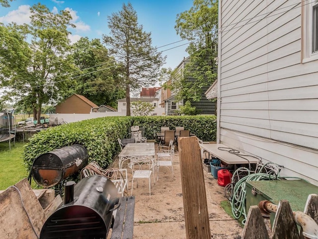 view of yard with a patio and a trampoline