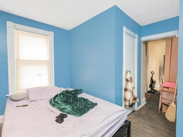 bedroom with dark hardwood / wood-style floors