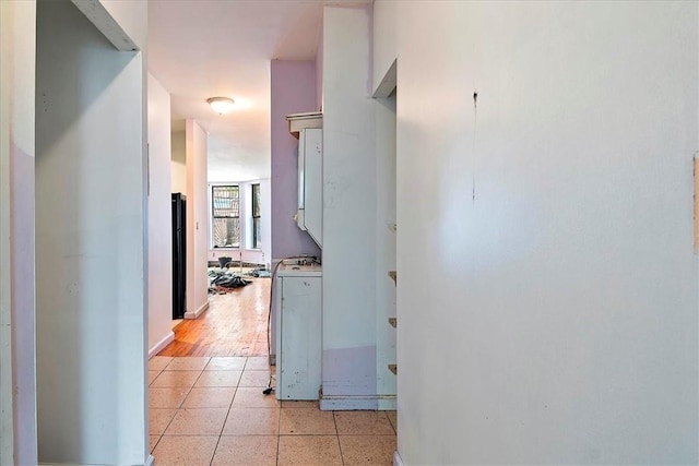 hallway featuring light wood-type flooring and washer / clothes dryer