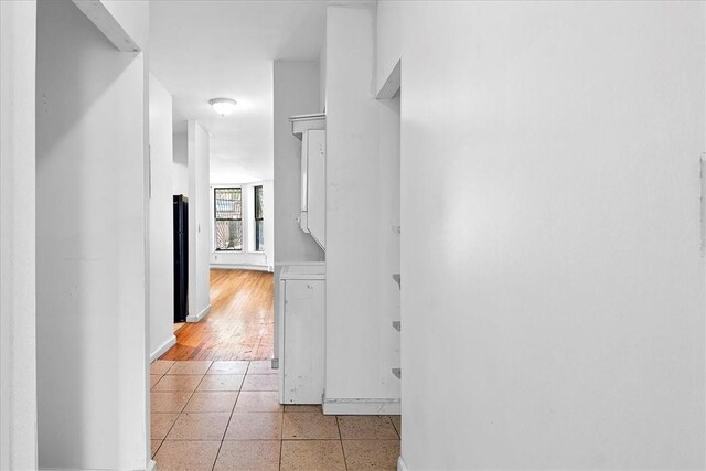 hallway with light hardwood / wood-style floors