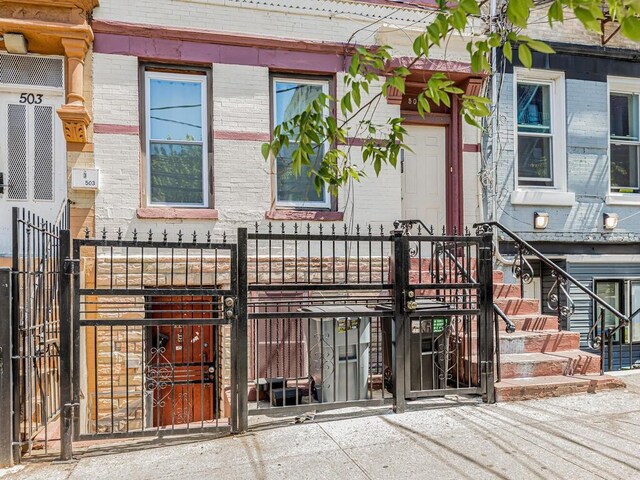 505 E 183rd St, Bronx, NY 10458 - entrance to property featuring brick siding and a gate