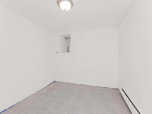 unfurnished room featuring a baseboard radiator