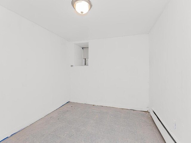 505 E 183rd St, Bronx, NY 10458 - spare room featuring a baseboard heating unit