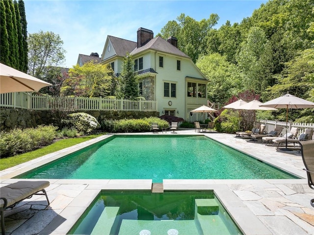 view of swimming pool with an in ground hot tub and a patio