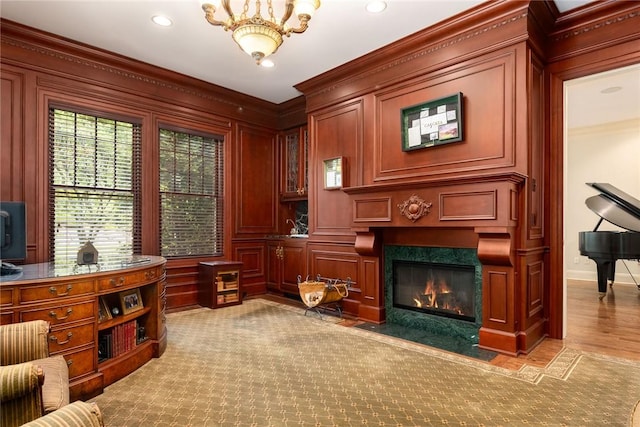 sitting room featuring hardwood / wood-style floors, ornamental molding, and a premium fireplace